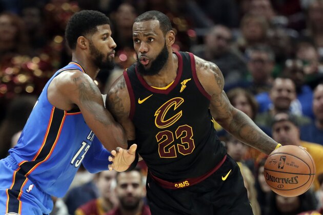 Cleveland Cavaliers' LeBron James, right, drives past Oklahoma City Thunder's Paul George in the second half of an NBA basketball game, Saturday, Jan. 20, 2018, in Cleveland. (AP Photo/Tony Dejak)