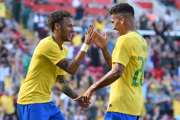 TOPSHOT - Brazil's striker Roberto Firmino (R) celebrates with Brazil's striker Neymar after scoring their second goal during the International friendly football match between Brazil and Croatia at Anfield in Liverpool on June 3, 2018. - Brazil won the game 2-0. (Photo by Oli SCARFF / AFP)        (Photo credit should read OLI SCARFF/AFP/Getty Images)