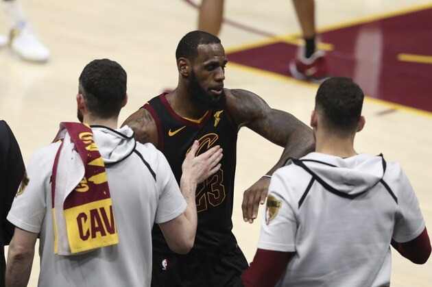 Cleveland Cavaliers' LeBron James greets teammates as he taken out in the second half of Game 4 of basketball's NBA Finals, Friday, June 8, 2018, in Cleveland. The Warriors defeated the Cavaliers 108-85. (AP Photo/Carlos Osorio)