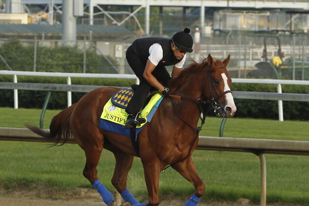 Justify, ridden by exercise rider Humberto Gomez, gallops at Churchill Downs in Louisville, Ky., Saturday, May 26, 2018 getting ready for The Belmont Stakes and a possible Triple Crown, in New York in June. (AP Photo/Garry Jones)