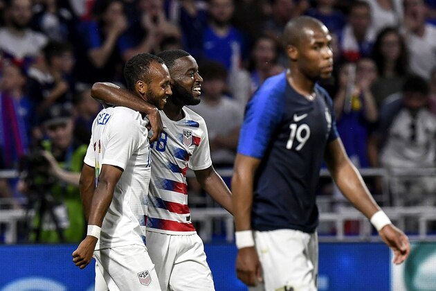 USA's midfielder Julian Green (L) celebrates with his teamates after scoring a goal during the friendly football match between France and USA on June 9 , 2018, at the Groupama Stadium in Decines-Charpieu near Lyon, central-eastern France. (Photo by JEFF PACHOUD / AFP)        (Photo credit should read JEFF PACHOUD/AFP/Getty Images)