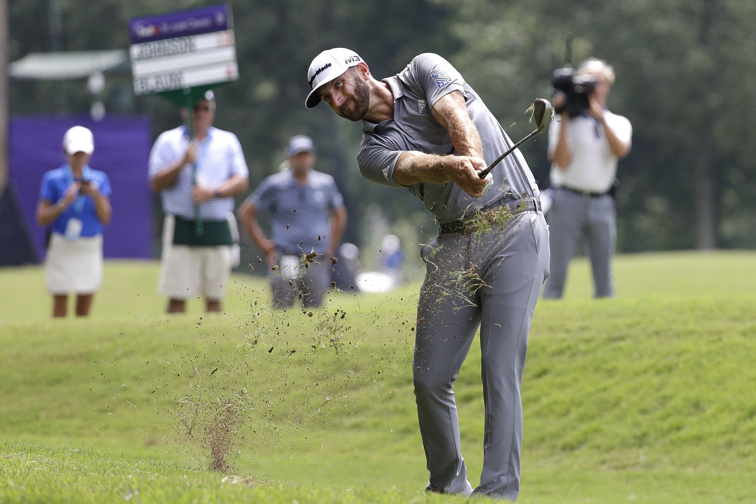 Dustin Johnson hits from the fairway on the ninth hole during the third round of the St. Jude Classic golf tournament Saturday, June 9, 2018, in Memphis, Tenn. (AP Photo/Mark Humphrey)