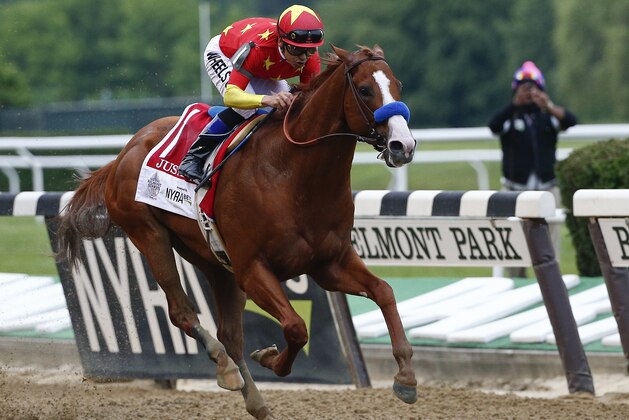 Justify (1), with jockey Mike Smith up, crosses the finish line to win the 150th running of the Belmont Stakes horse race and the Triple Crown, Sunday, June 10, 2018, in Elmont, N.Y. (AP Photo/Peter Morgan)