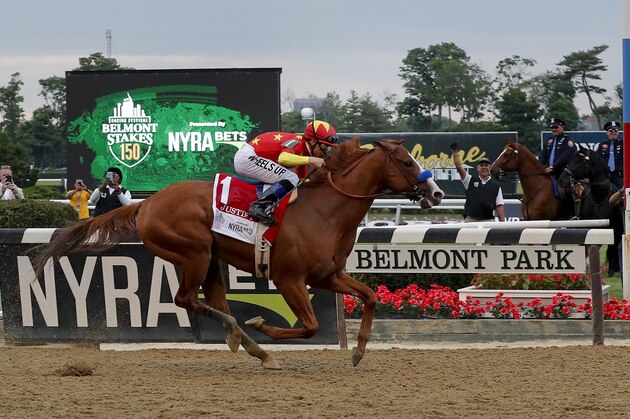 Justify (1), with jockey Mike Smith up, crosses the finish line to win the 150th running of the Belmont Stakes horse race, Saturday, June 9, 2018, in Elmont, N.Y. (AP Photo/Julie Jacobson)