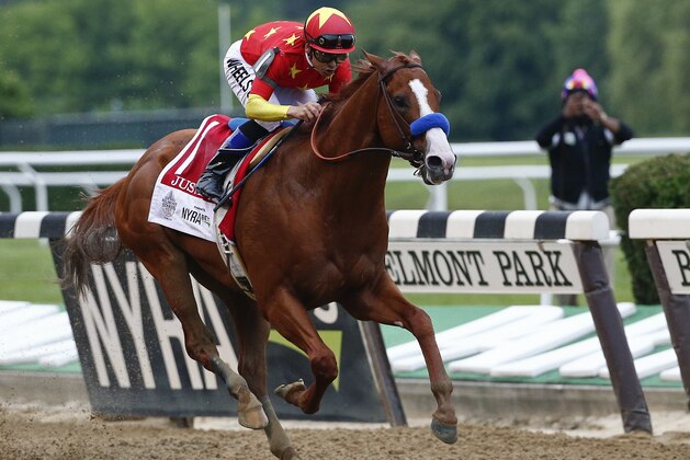 CORRECTS DATE TO SATURDAY, JUNE 9, NOT SUNDAY, JUNE 10 - Justify (1), with jockey Mike Smith up, crosses the finish line to win the 150th running of the Belmont Stakes horse race and the Triple Crown, Saturday, June 9, 2018, in Elmont, N.Y. (AP Photo/Peter Morgan)