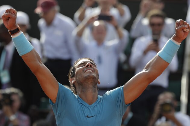 Spain's Rafael Nadal raises his arms after defeating Argentina's Juan Martin Del Potro during their semifinal match of the French Open tennis tournament at the Roland Garros stadium, Friday, June 8, 2018 in Paris. Nadal won 6-4, 6-1, 6-2. (AP Photo/Alessandra Tarantino)