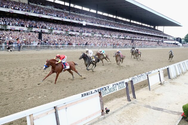 ELMONT, NY - JUNE 09:  Justify #1, ridden by jockey Mike Smith crosses the finish line to win the 150th running of the Belmont Stakes at Belmont Park on June 9, 2018 in Elmont, New York. Justify becomes the thirteenth Triple Crown winner and the first since American Pharoah in 2015.  (Photo by Al Bello/Getty Images)