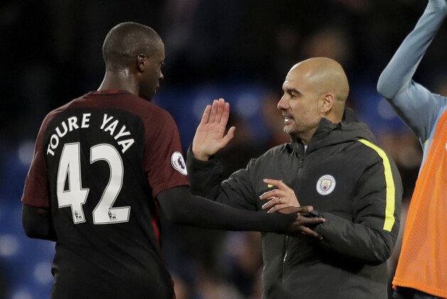 Manchester City's Yaya Toure, who scored both their goals, celebrates with his head coach Pep Guardiola after the English Premier League soccer match between Crystal Palace and Manchester City at Selhurst Park stadium in London, Saturday, Nov. 19, 2016. (AP Photo/Matt Dunham)
