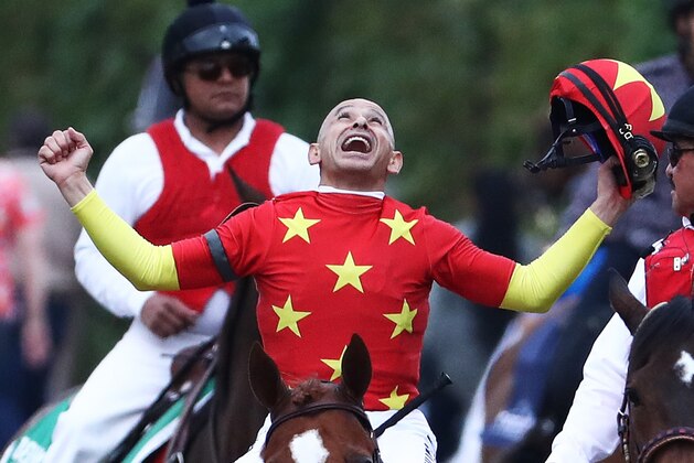 ELMONT, NY - JUNE 09:  Jockey Mike Smith celebrates atop of Justify #1 during the 150th running of the Belmont Stakes at Belmont Park on June 9, 2018 in Elmont, New York. Justify becomes the thirteenth Triple Crown winner and the first since American Pharoah in 2015.  (Photo by Al Bello/Getty Images)