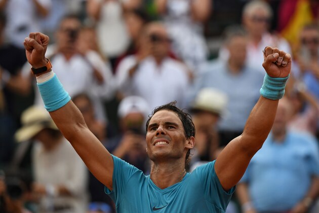Spain's Rafael Nadal celebrates after victory over Austria's Dominic Thiem during their men's singles final match on day fifteen of The Roland Garros 2018 French Open tennis tournament in Paris on June 10, 2018. (Photo by Christophe ARCHAMBAULT / AFP)        (Photo credit should read CHRISTOPHE ARCHAMBAULT/AFP/Getty Images)