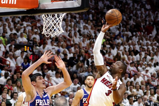 Miami Heat guard Dwyane Wade (3) shoots and scores in the fourth quarter as Philadelphia 76ers forward Ersan Ilyasova (23) defends during Game 4 of a first-round NBA basketball playoff series Saturday, April 21, 2018, in Miami. The 76ers won 106-102. (AP Photo/Joe Skipper)