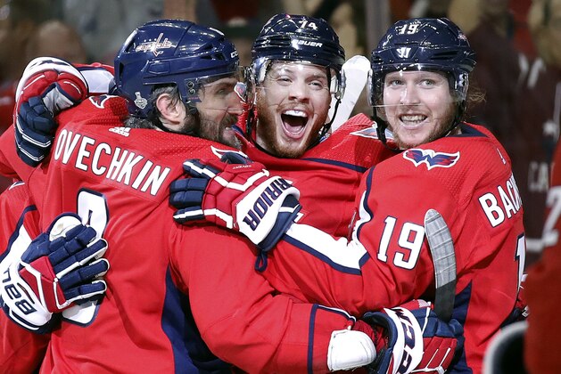 Washington Capitals defenseman John Carlson, center, celebrates his goal against the Vegas Golden Knights with Alex Ovechkin, left, of Russia, and Nicklas Backstrom, right, of Sweden, during the second period in Game 4 of the NHL hockey Stanley Cup Final, Monday, June 4, 2018, in Washington. (AP Photo/Alex Brandon)