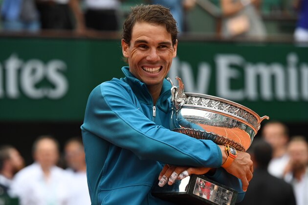 Spain's Rafael Nadal poses with the Mousquetaires Cup (The Musketeers) after his victory in the men's singles final match against Austria's Dominic Thiem, on day fifteen of The Roland Garros 2018 French Open tennis tournament in Paris on June 10, 2018. (Photo by Christophe ARCHAMBAULT / AFP)        (Photo credit should read CHRISTOPHE ARCHAMBAULT/AFP/Getty Images)