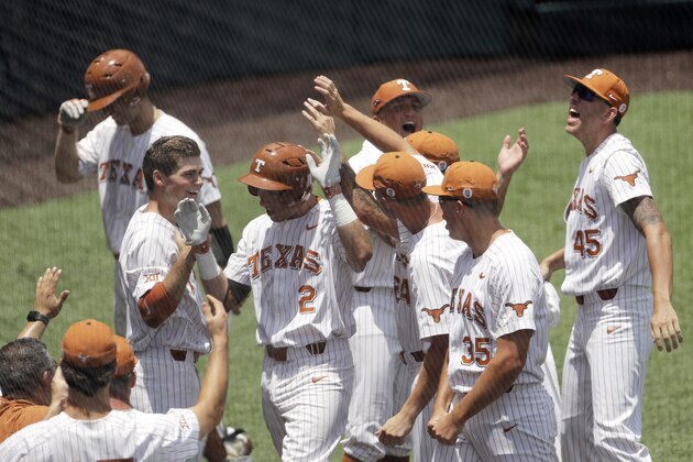 Texas' Kody Clemens (2) celebrates with teammates after he hit a solo home run against Tennessee Tech pitcher Alex Hursey in the third inning of an NCAA college super regional baseball game, Monday, June 11, 2018, in Austin, Texas. (AP Photo/Eric Gay)