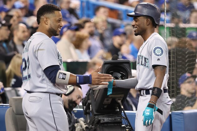 TORONTO, ON - MAY 8: Dee Gordon #9 of the Seattle Mariners is congratulated by Robinson Cano #22 after scoring a run in the third inning during MLB game action against the Toronto Blue Jays at Rogers Centre on May 8, 2018 in Toronto, Canada. (Photo by Tom Szczerbowski/Getty Images)