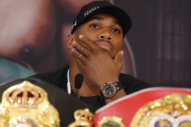 World Heavyweight boxers Anthony Joshua of Britain pauses during a media conference with New Zealand's Joseph Parker in London, Tuesday, Jan. 16, 2018. Their unification title bout with Joshua's IBF, WBA (Super) and IBO heavyweight titles and Parker's WBO heavyweight title on the line will take place at the Principality Stadium in Cardiff on March 31, 2018.(AP Photo/Frank Augstein)