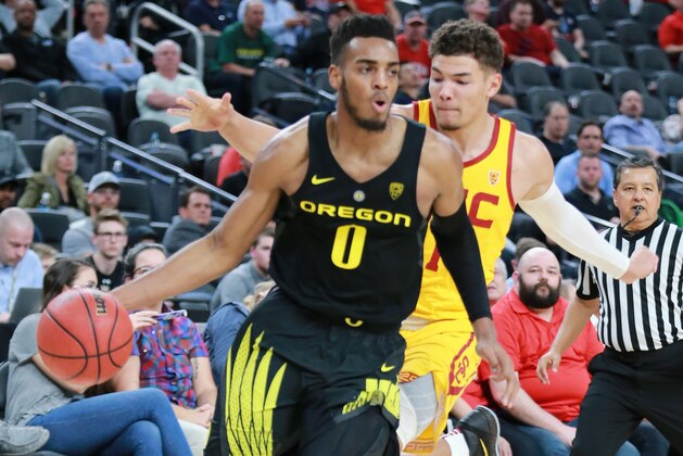 LAS VEGAS, NV - MARCH 09:  Troy Brown #0 of the Oregon Ducks handles the ball against Jordan Usher #1 of the USC Trojans during a semifinal game of the Pac-12 basketball tournament at T-Mobile Arena on March 9, 2018 in Las Vegas, Nevada.  (Photo by Leon Bennett/Getty Images)