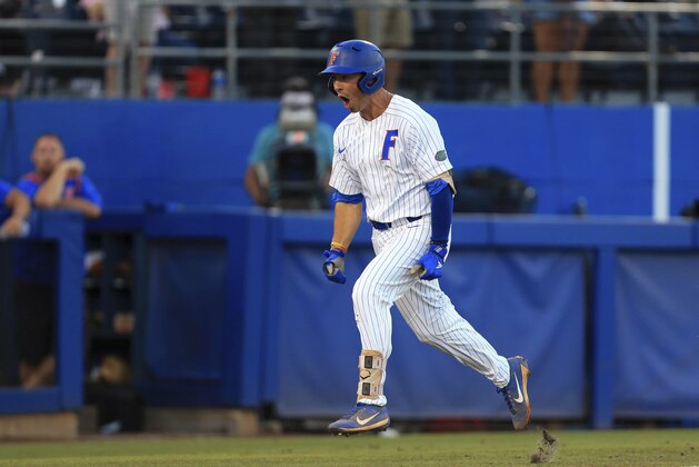 Florida's Jonathan India celebrates after hitting a home run against Auburn during the first inning of an NCAA Super Regional college baseball game Monday, June 11, 2018, in Gainesville, Fla. (AP Photo/Matt Stamey)