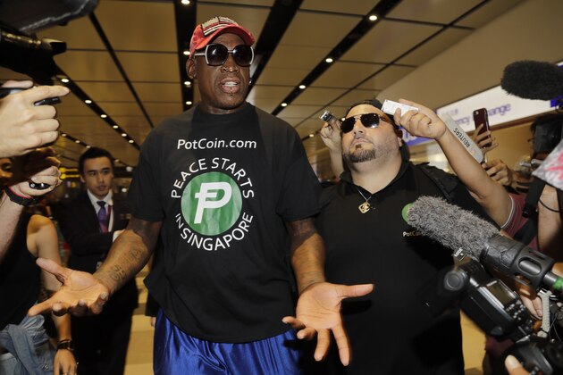 Former NBA basketball player Dennis Rodman, and Chris Volo, right, arrive at Singapore's Changi Airport on Tuesday, June 12, 2018. (AP Photo/Wong Maye-E)