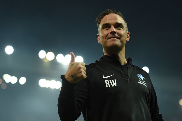 English musician Robbie Williams celebrates after winning a England V Soccer Aid World XI charity football match for Soccer Aid for Unicef at Old Trafford in Manchester, northwest England on June 10, 2018. (Photo by Oli SCARFF / AFP)        (Photo credit should read OLI SCARFF/AFP/Getty Images)