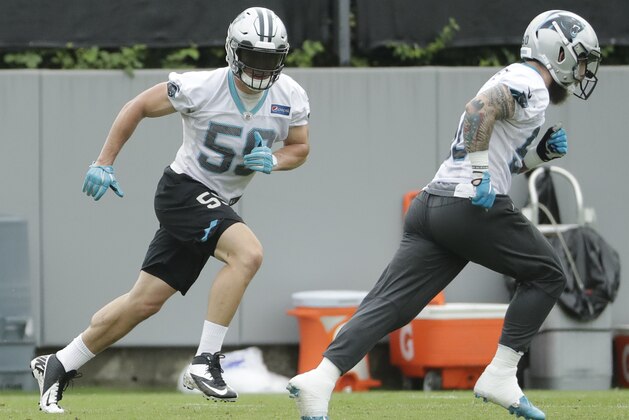 Carolina Panthers' Luke Kuechly, left, runs a drill during practice at the NFL football team's facility in Charlotte, N.C., Tuesday, May 29, 2018. (AP Photo/Chuck Burton)