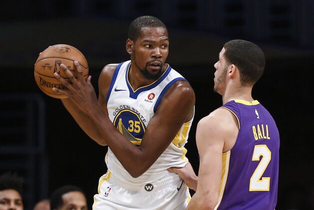 Golden State Warriors forward Kevin Durant, left, is defended by Los Angeles Lakers guard Lonzo Ball during the first half of an NBA basketball game Wednesday, Nov. 29, 2017, in Los Angeles. (AP Photo/Ringo H.W. Chiu)