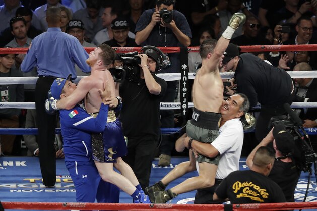 Canelo Alvarez, left, and Gennady Golovkin celebrate following a middleweight title fight Sunday, Sept. 17, 2017, in Las Vegas. The fight was called a draw. (AP Photo/Isaac Brekken)