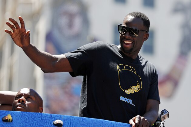 Golden State Warriors' Draymond Green waves to fans during the team's NBA basketball championship parade, Tuesday, June 12, 2018, in Oakland, Calif. (AP Photo/Tony Avelar)