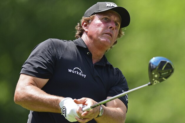 Phil Mickelson follows his tee shot on the 18th hole during the third round of the Memorial golf tournament Saturday, June 2, 2018, in Dublin, Ohio. (AP Photo/David Dermer)