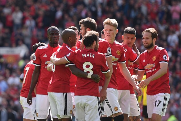 Manchester United players celebrate after Manchester United's English striker Marcus Rashford scored the opening goal during the English Premier League football match between Manchester United and Watford at Old Trafford in Manchester, north west England, on May 13, 2018. (Photo by Oli SCARFF / AFP) / RESTRICTED TO EDITORIAL USE. No use with unauthorized audio, video, data, fixture lists, club/league logos or 'live' services. Online in-match use limited to 75 images, no video emulation. No use in betting, games or single club/league/player publications. /         (Photo credit should read OLI SCARFF/AFP/Getty Images)