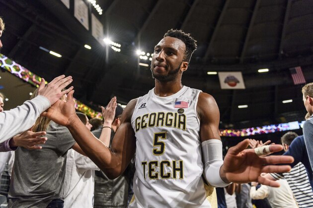 FILE - In this March 1, 2018, file photo, Georgia Tech guard Josh Okogie (5) celebrates with fans after their win over North Carolina State in an NCAA college basketball game in Atlanta. Okogie plans to skip his final two college seasons to enter the NBA draft, announcing his intention Thursday, March 15, 2018, through the school. He will not hire an agent, leaving open the option of returning to the Yellow Jackets. (AP Photo/Danny Karnik, File)