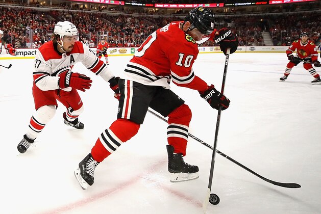 CHICAGO, IL - MARCH 08:  Patrick Sharp #10 of the Chicago Blackhawks controls the puck in front of Justin Faulk #27 of the Carolina Hurricanes at the United Center on March 8, 2018 in Chicago, Illinois. The Hurricanes defeated the Blackhawks 3-2. (Photo by Jonathan Daniel/Getty Images)