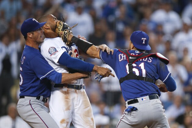 Texas Rangers starting pitcher Cole Hamels, left, restrains Los Angeles Dodgers' Matt Kemp as Kemp scuffles with Rangers catcher Robinson Chirinos during the third inning of a baseball game Wednesday, June 13, 2018, in Los Angeles. (AP Photo/Jae C. Hong)