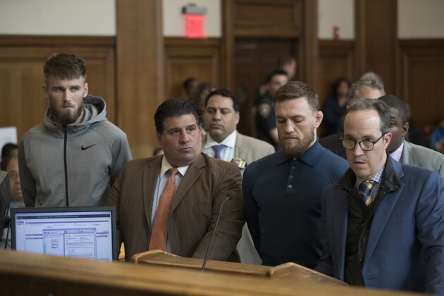 CORRECTS TO BROOKLYN CRIMINAL COURT, NOT BROOKLYN FEDERAL COURT-Ultimate fighting stars Conor McGregor, second from right, and Cian Cowley, left, stand with lawyers Jim Walden, right, and John Arlia during their arraignment in Brooklyn Criminal Court, Friday, April 6, 2018 in New York. McGregor is facing criminal charges in the wake of a backstage melee he allegedly instigated that has forced the removal of three fights from UFC's biggest card of the year. Video footage appears to show the promotion's most bankable star throwing a hand truck at a bus full of fighters after a Thursday news conference for UFC 223 at Brooklyn's Barclays Center. (AP Photo/Mary Altaffer, Pool)