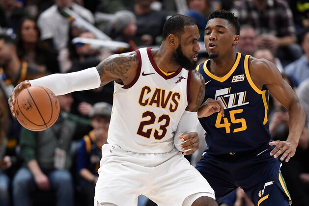 SALT LAKE CITY, UT - DECEMBER 30: LeBron James #23 of the Cleveland Cavaliers is defended by Donovan Mitchell #45 of the Utah Jazz in the second half of the 104-101 win by the Utah Jazz at Vivint Smart Home Arena on December 30, 2017 in Salt Lake City, Utah. NOTE TO USER: User expressly acknowledges and agrees that, by downloading and or using this photograph, User is consenting to the terms and conditions of the Getty Images License Agreement. (Photo by Gene Sweeney Jr./Getty Images)