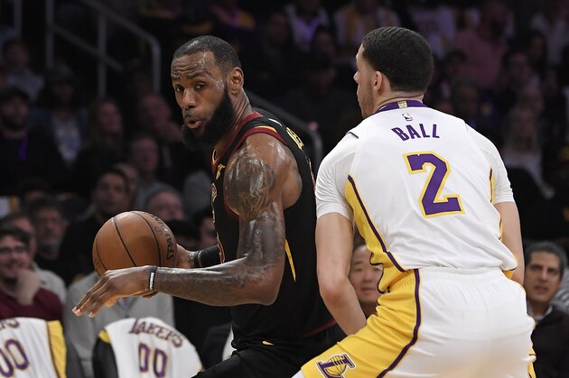 Cleveland Cavaliers forward LeBron James, left, tries to get past Los Angeles Lakers guard Lonzo Ball during the first half of an NBA basketball game, Sunday, March 11, 2018, in Los Angeles. (AP Photo/Mark J. Terrill)
