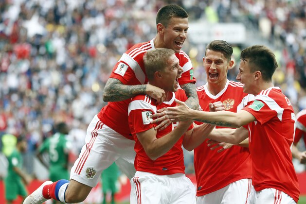 Russia's Yuri Gazinsky celebrates with teammates after scoring his side's first goal during the group A match between Russia and Saudi Arabia which opens the 2018 soccer World Cup at the Luzhniki stadium in Moscow, Russia, Thursday, June 14, 2018. (AP Photo/Matthias Schrader)