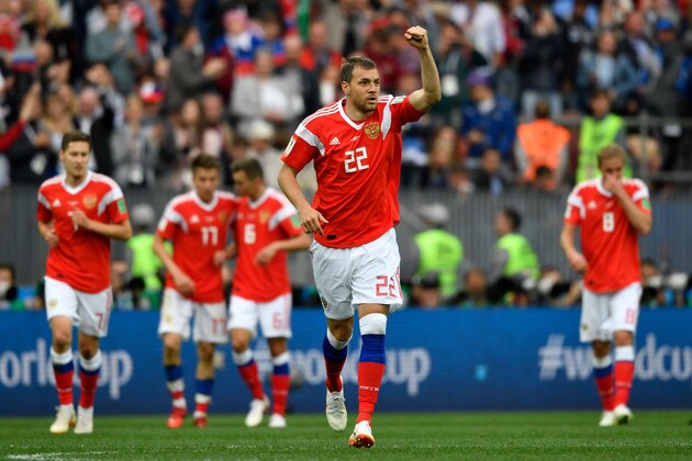 Russia's forward Artem Dzyuba (C) celebrates scoring the 3-0 goal with his team-mates during the Russia 2018 World Cup Group A football match between Russia and Saudi Arabia at the Luzhniki Stadium in Moscow on June 14, 2018. (Photo by Alexander NEMENOV / AFP) / RESTRICTED TO EDITORIAL USE - NO MOBILE PUSH ALERTS/DOWNLOADS / The erroneous mention[s] appearing in the metadata of this photo by Alexander NEMENOV has been modified in AFP systems in the following manner: [Russia's forward Artem Dzyuba celebrates (C) scoring the 3-0 goal ] instead of [Russia's midfielder Denis Cheryshev (C) celebrates scoring the 2-0 goal]. Please immediately remove the erroneous mention[s] from all your online services and delete it (them) from your servers. If you have been authorized by AFP to distribute it (them) to third parties, please ensure that the same actions are carried out by them. Failure to promptly comply with these instructions will entail liability on your part for any continued or post notification usage. Therefo