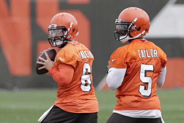 Cleveland Browns quarterbackd Baker Mayfield (6) and Tyrod Taylor (5) look to throw during practice at the NFL football team's training camp facility, Tuesday, June 12, 2018, in Berea, Ohio. (AP Photo/Tony Dejak)