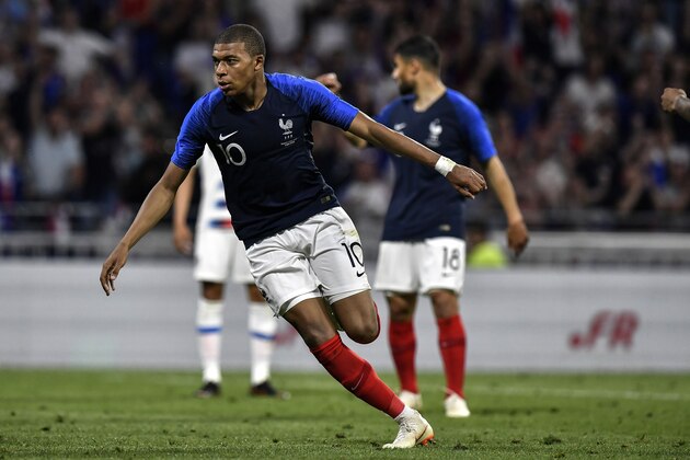 France's forward Kylian MBappe celebrates after scoring a goal during the friendly football match between France and USA at the at the Parc Olympique lyonnais stadium in Decines-Charpieu, near Lyon on June 9, 2018. (Photo by JEFF PACHOUD / AFP)        (Photo credit should read JEFF PACHOUD/AFP/Getty Images)