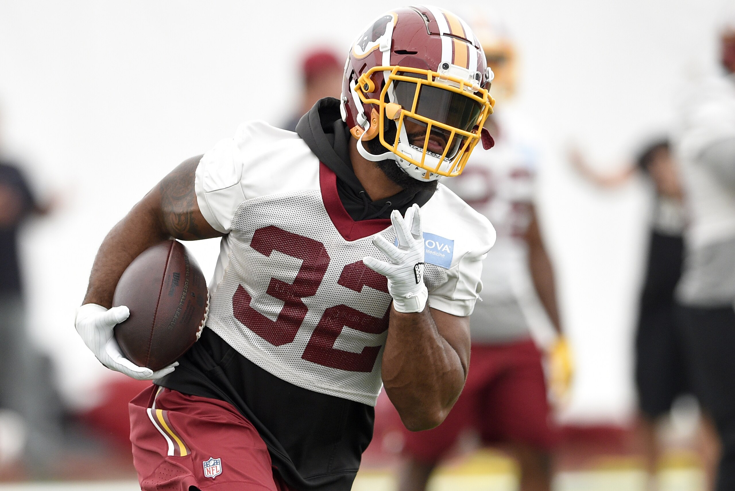 Washington Redskins running back Samaje Perine (32) runs with the ball during an NFL football team practice, Wednesday, June 13, 2018, in Ashburn, Va. (AP Photo/Nick Wass)