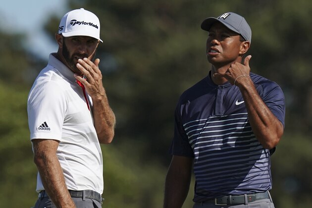 Tiger Woods, right, motions to call over an official after the wind moved his ball on the tenth green after he had already addressed it during the first round of the U.S. Open Golf Championship, Thursday, June 14, 2018, in Southampton, N.Y. Dustin Johnson looked on. (AP Photo/Carolyn Kaster)