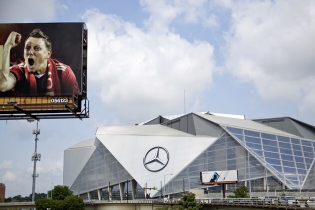 A billboard for Atlanta's MLS soccer team stands next to Mercedes-Benz Stadium where the team plays in Atlanta, Wednesday, June 13, 2018. The 2026 World Cup will return to the U.S. for the first time since 1994. Atlanta's new Mercedes-Benz Stadium was shown prominently in the video used in the North American pitch for the bid. (AP Photo/David Goldman)