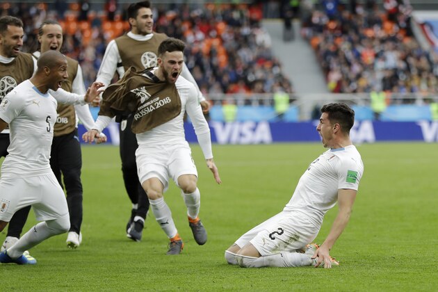 Uruguay's Jose Gimenez, right, celebrates with his teammates after scoring his side's opening goal during the group A match between Egypt and Uruguay at the 2018 soccer World Cup in the Yekaterinburg Arena in Yekaterinburg, Russia, Friday, June 15, 2018. (AP Photo/Natacha Pisarenko)