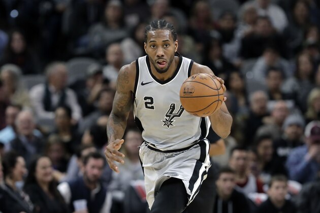 San Antonio Spurs forward Kawhi Leonard (2) moves the ball up court during the second half of an NBA basketball game against the Denver Nuggets, Saturday, Jan. 13, 2018, in San Antonio. San Antonio won 112-80. (AP Photo/Eric Gay)
