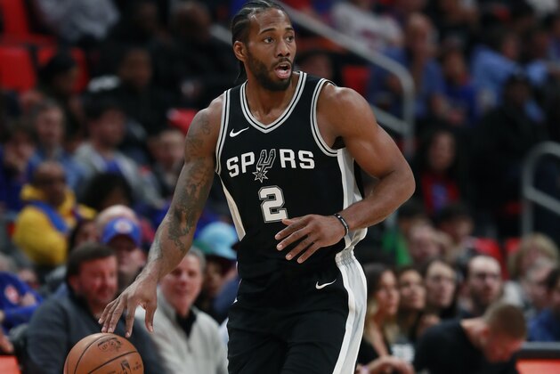 San Antonio Spurs forward Kawhi Leonard (2) brings the ball up court during the first half of an NBA basketball game against the Detroit Pistons, Saturday, Dec. 30, 2017, in Detroit. (AP Photo/Carlos Osorio)