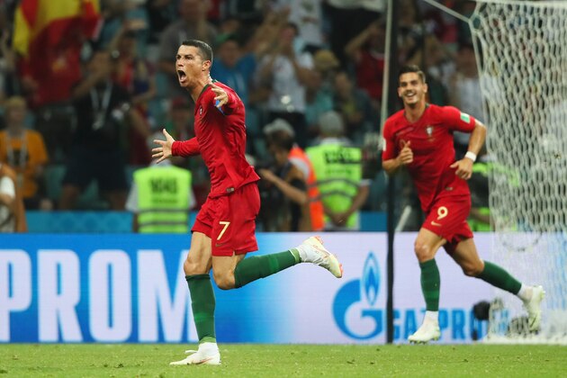 SOCHI, RUSSIA - JUNE 15:  Cristiano Ronaldo of Portugal celebrates scoring a goal to make it 3-3 during the 2018 FIFA World Cup Russia group B match between Portugal and Spain at Fisht Stadium on June 15, 2018 in Sochi, Russia. (Photo by Matthew Ashton - AMA/Getty Images)