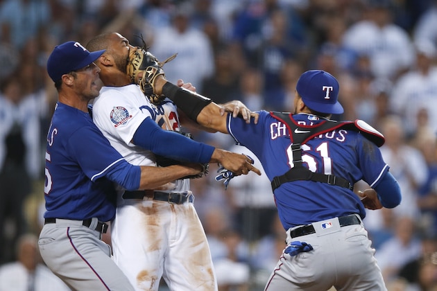 Texas Rangers starting pitcher Cole Hamels, left, restrains Los Angeles Dodgers' Matt Kemp as Kemp scuffles with Rangers catcher Robinson Chirinos during the third inning of a baseball game Wednesday, June 13, 2018, in Los Angeles. (AP Photo/Jae C. Hong)