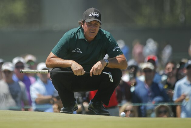 Phil Mickelson lines up a shot on the fourth green during the third round of the U.S. Open Golf Championship, Saturday, June 16, 2018, in Southampton, N.Y. (AP Photo/Carolyn Kaster)