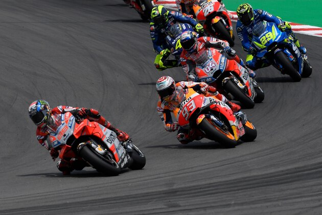 (FromL) Ducati Team's Spanish rider Jorge Lorenzo, Repsol Honda Team's Spanish rider Marc Marquez and Ducati Team's Italian rider Andrea Dovizioso ride during the Catalunya MotoGP Grand Prix race at the Catalunya racetrack in Montmelo, near Barcelona on June 17, 2018. (Photo by LLUIS GENE / AFP)        (Photo credit should read LLUIS GENE/AFP/Getty Images)